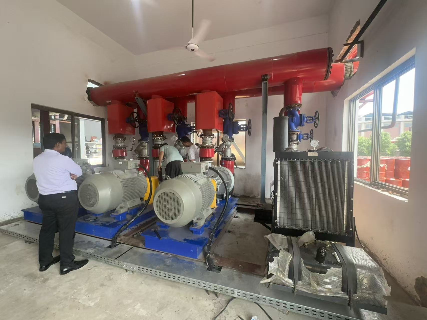 Thermal oil circulation pumps and connected red pipework at the textile mill